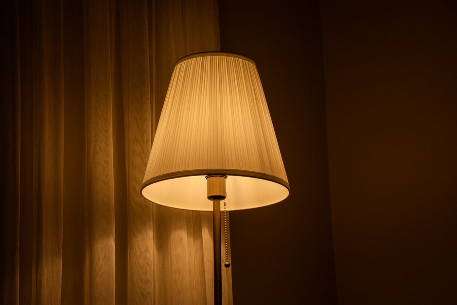 Softly glowing table lamp in a cozy room creates a warm and inviting atmosphere.